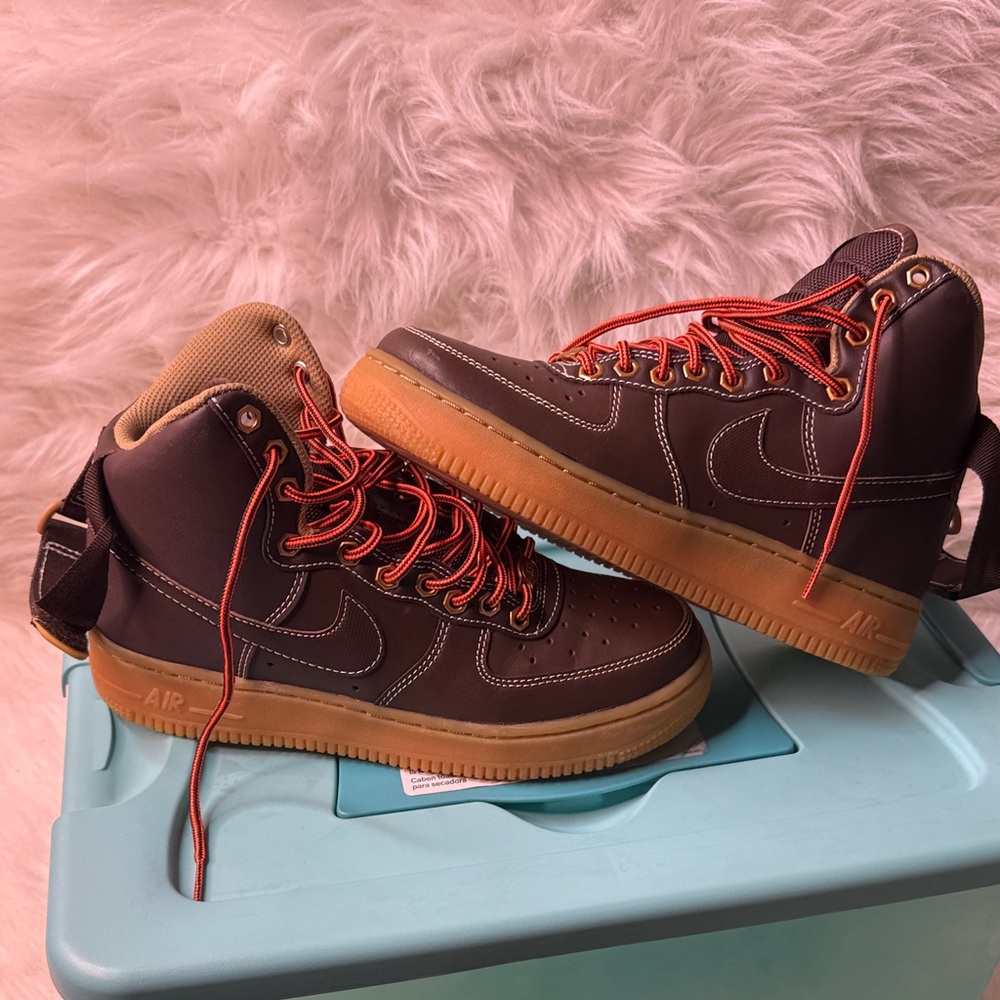 Stylish Brown High-Top Nike Air Force Sneakers with Orange Laces